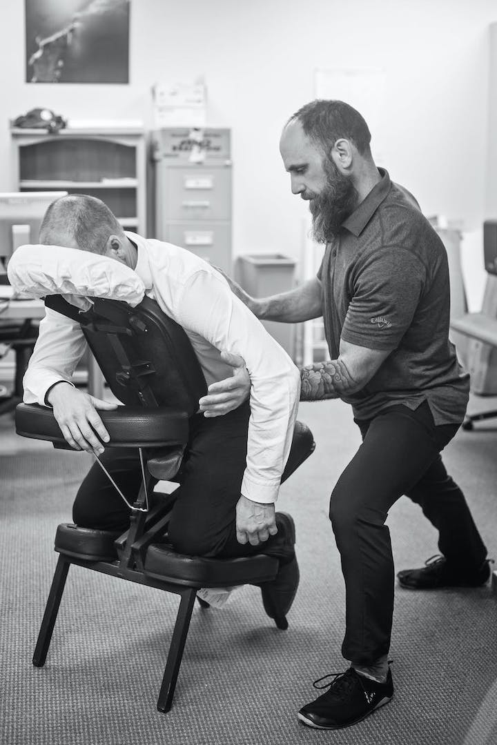 A physical therapist administering back pain relief in office.
