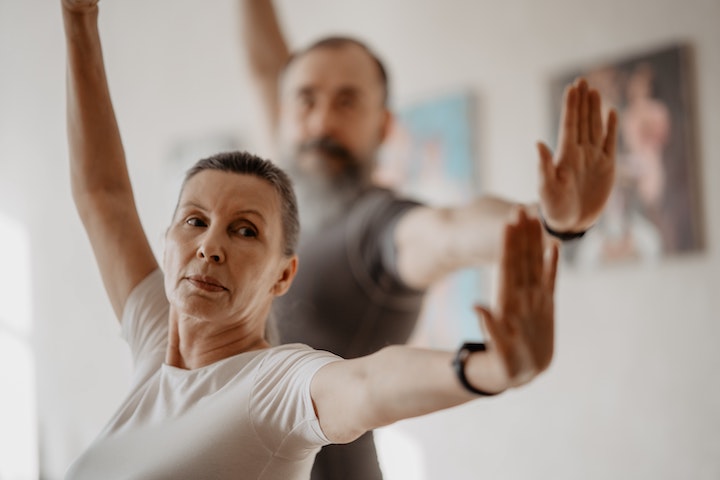 Clore-up with an almost-elderly woman balancing herself with a man pictured in blurred mode behind her.