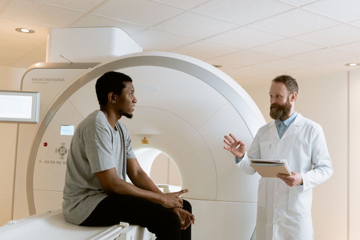 A doctor discussing with a patient right after an MRI session.