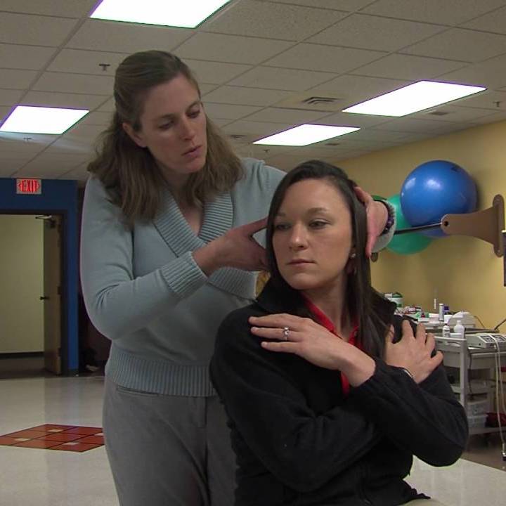 A vestibular physiotherapist counseling a patient with a treatment plan for dizziness and vertigo.