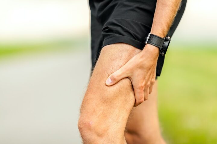 A runner in pain at the hamstring muscle.