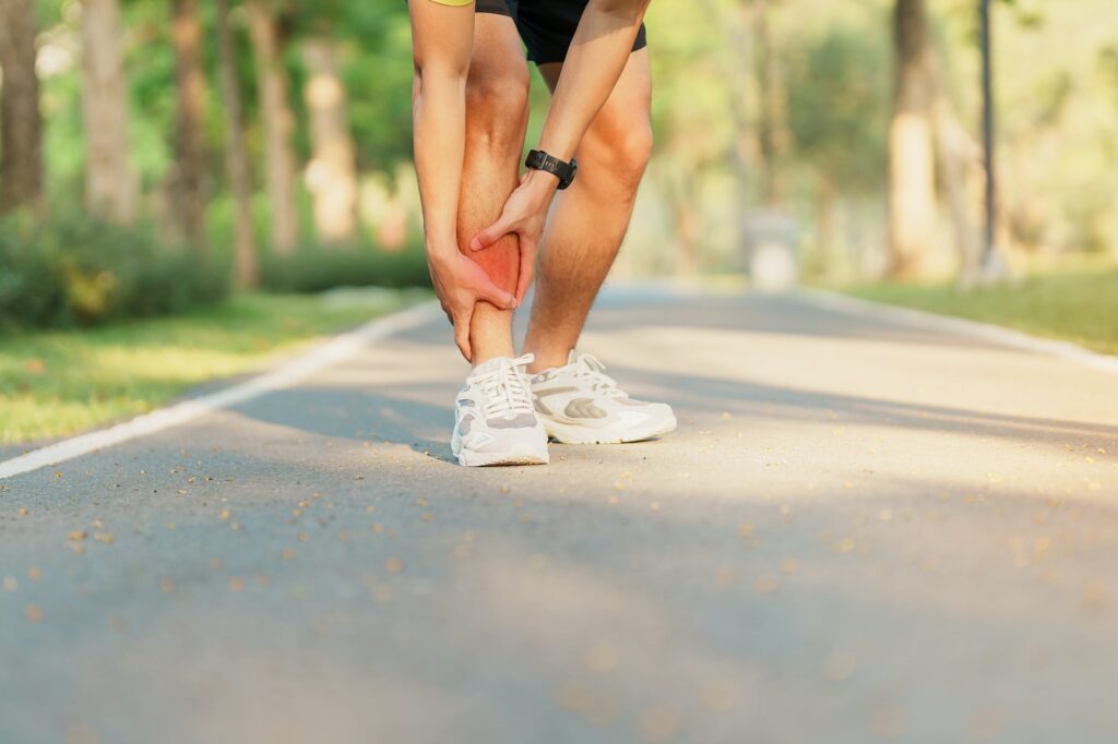 Young adult male with his muscle pain during running.