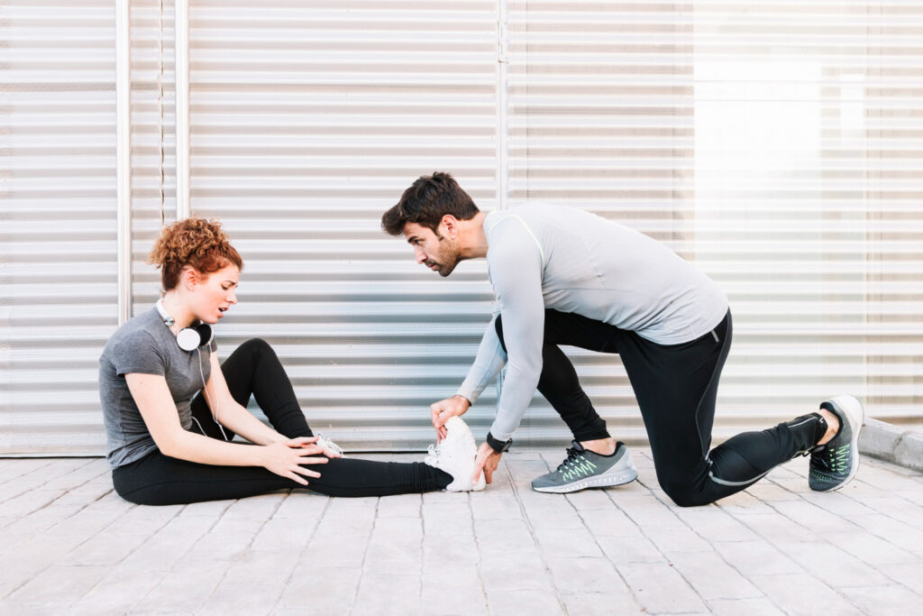  A man and woman perform exercises on the floor, illustrating their commitment to overcoming common fitness challenges.