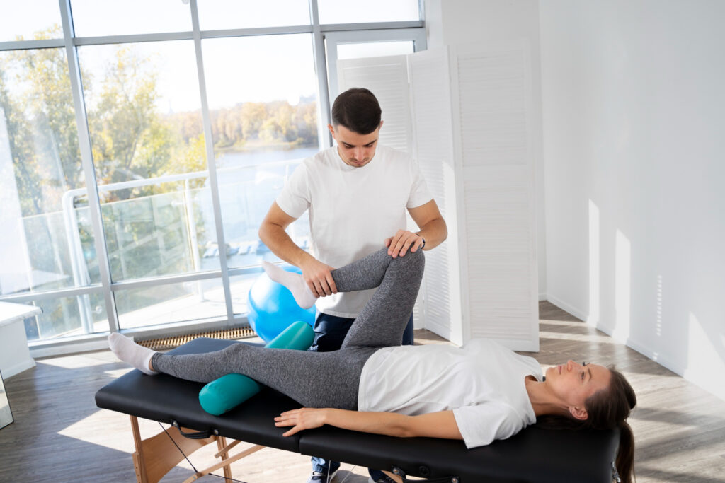 A man and woman engage in a physical therapy session, focusing on rehabilitation for common conditions.