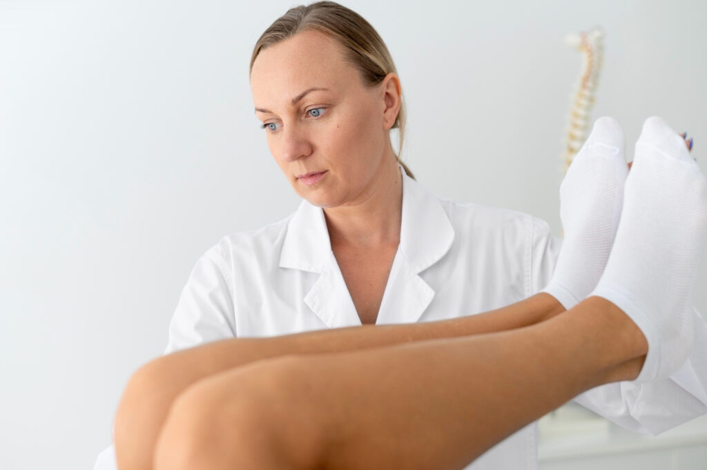 A woman consults with a doctor as he examines her leg for Fat Pad Impingement diagnosis.