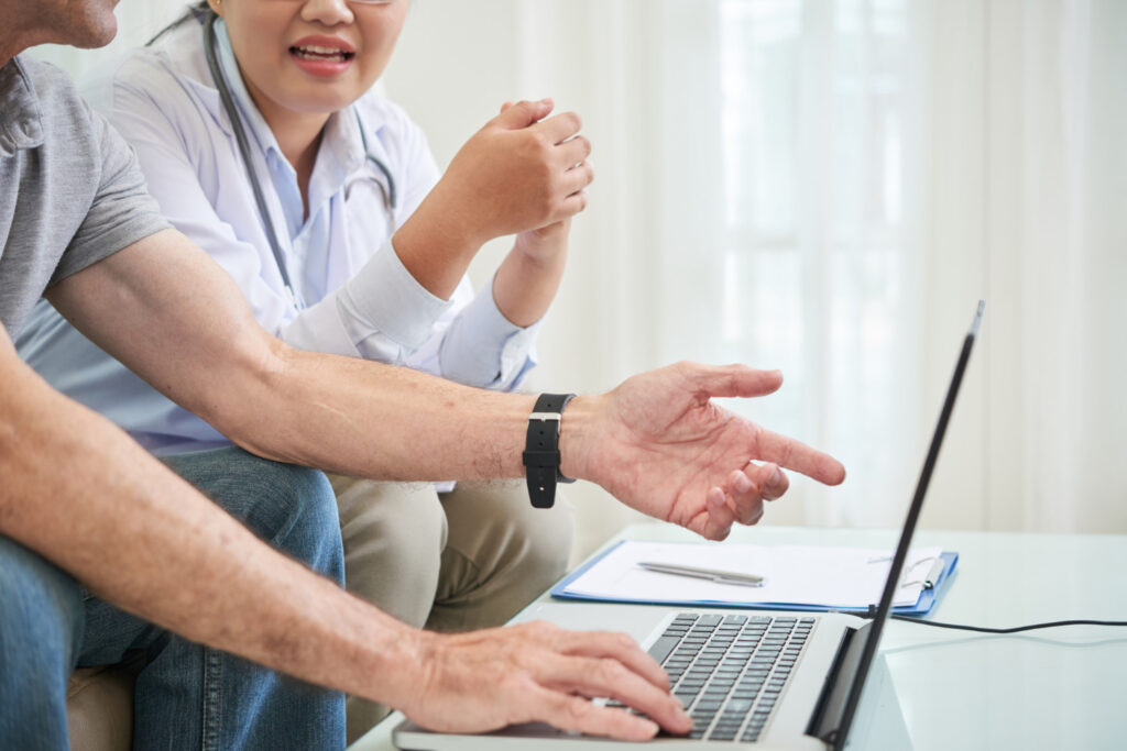 A man and woman relax together on a couch, emphasizing the importance of quality physiotherapy care when booking online.