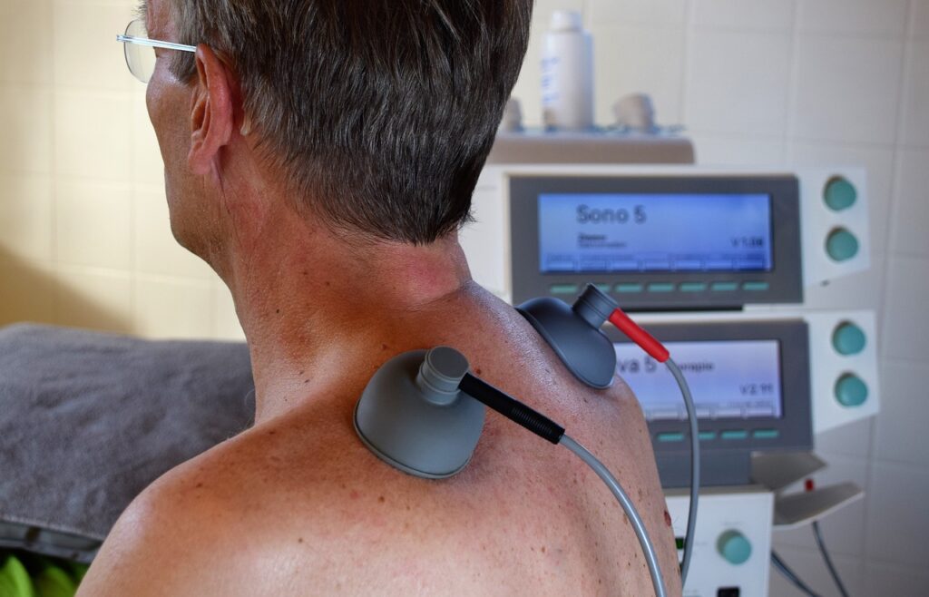  A man using a TENS unit back massager, demonstrating effective pain relief and relaxation techniques for TENS Unit for Best Results