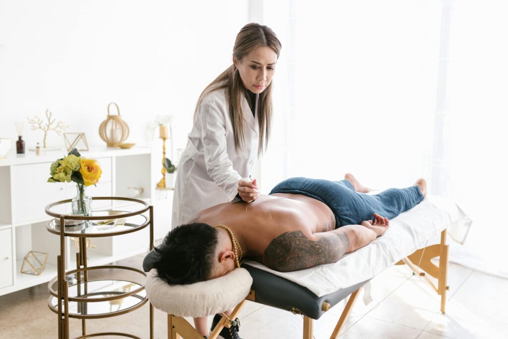 2. A woman enjoying a back massage, emphasizing therapeutic benefits while considering dry needling risks in Australia.