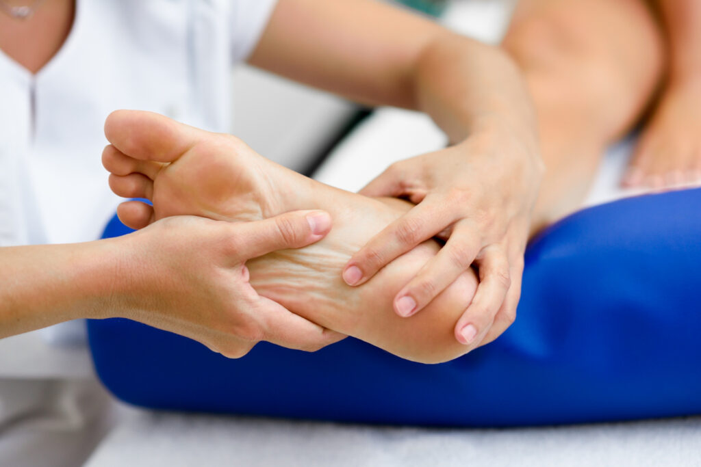 A person receiving a soothing foot massage in a clinic, focusing on heel pad symptoms and diagnosis.