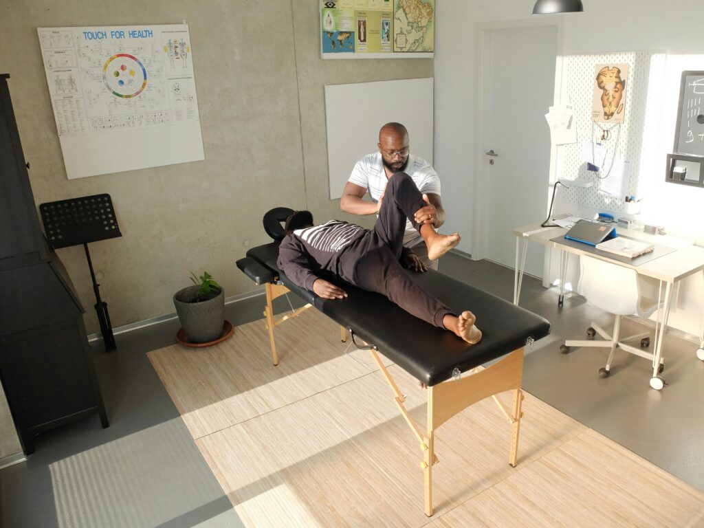  A man performing a massage on a table in a calm room, emphasizing therapeutic techniques for relaxation.