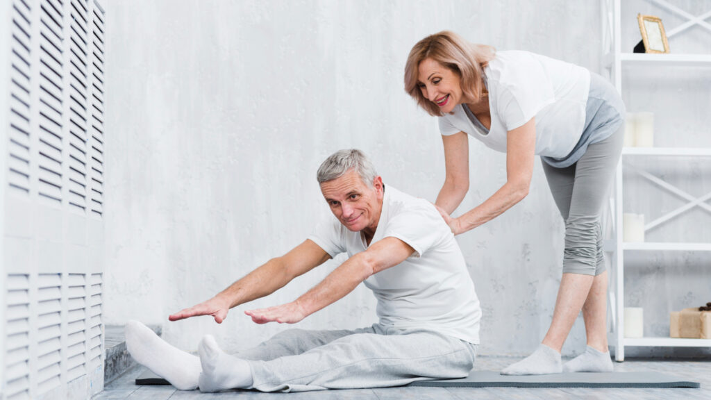 A man and woman practicing yoga together, demonstrating safe stretching techniques in a serene environment.