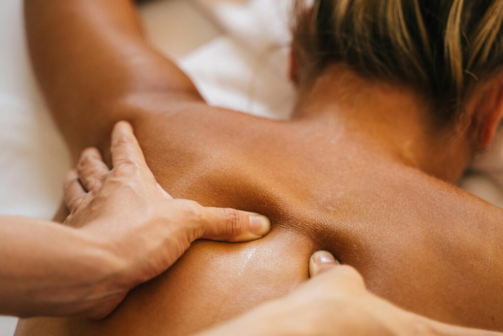 A woman enjoys a soothing back massage in a spa, focusing on effective treatments for relieving muscle knots.