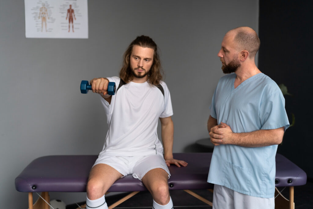 Physiotherapist demonstrating muscle tightness prevention techniques with a patient in a sports clinic setting.