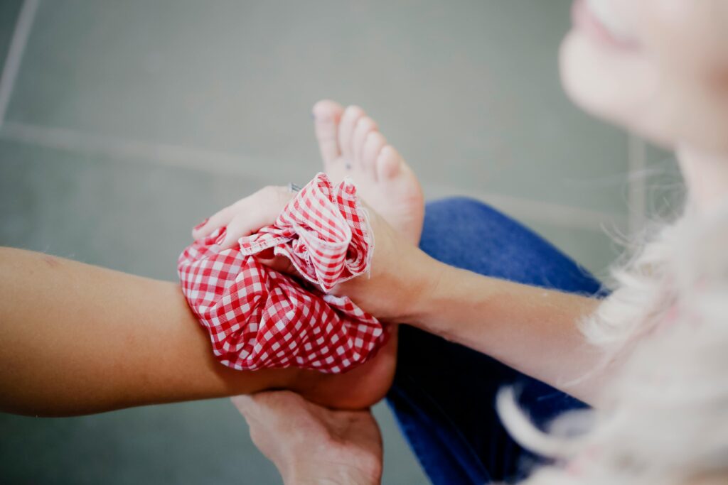  A woman holds a red and white checked towel, symbolizing comfort and care in pain management and medication.
