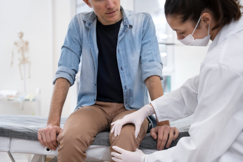 A doctor examines a man to discuss preventive measures and treatment options for knee pain.
