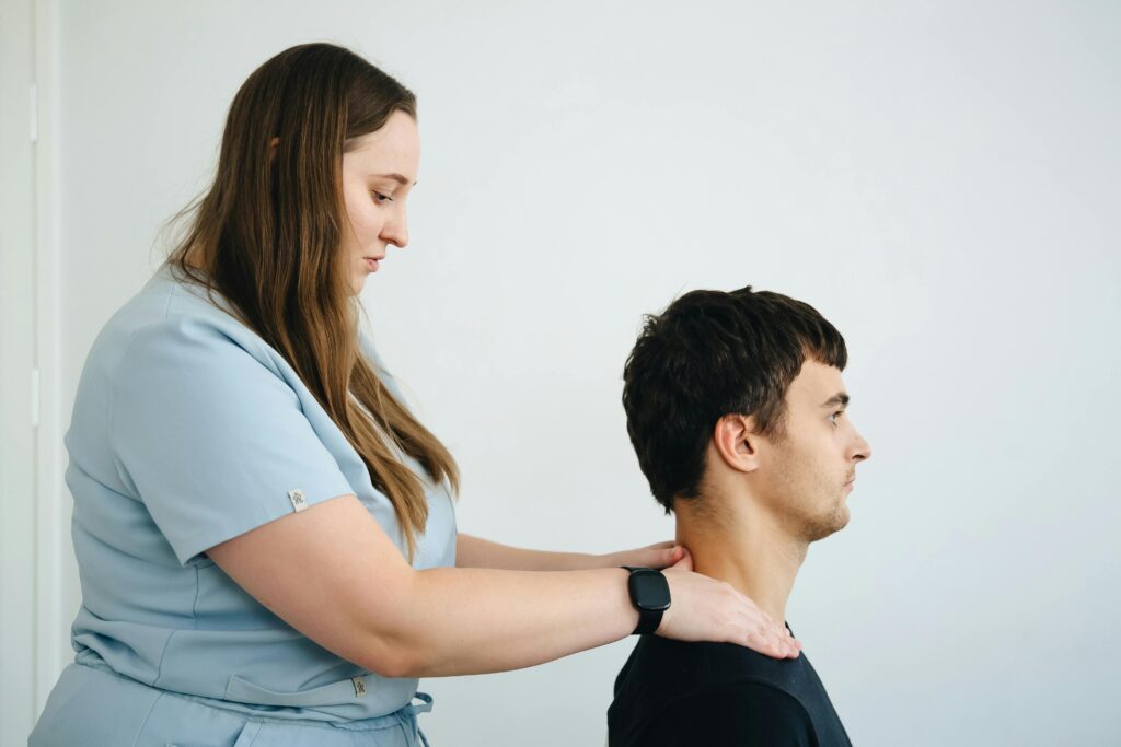 A woman assists a man with physical therapy, demonstrating techniques for rehabilitation and recovery.